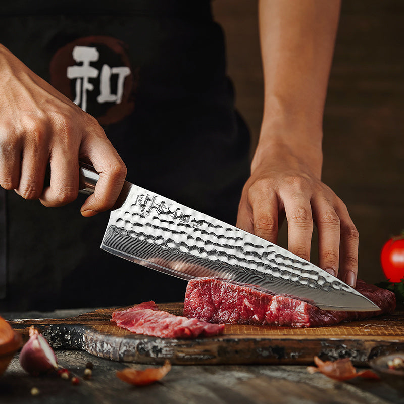 Hezhen B30R Master koksmes snijdt vlees op een plank