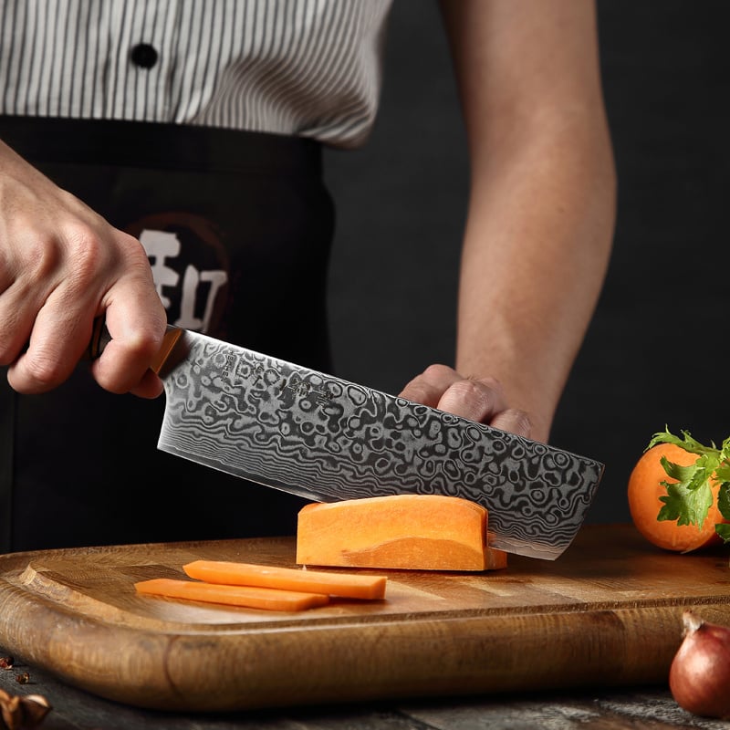 Persoon snijdt zoete aardappel met Hezhen B30 Master koksmes