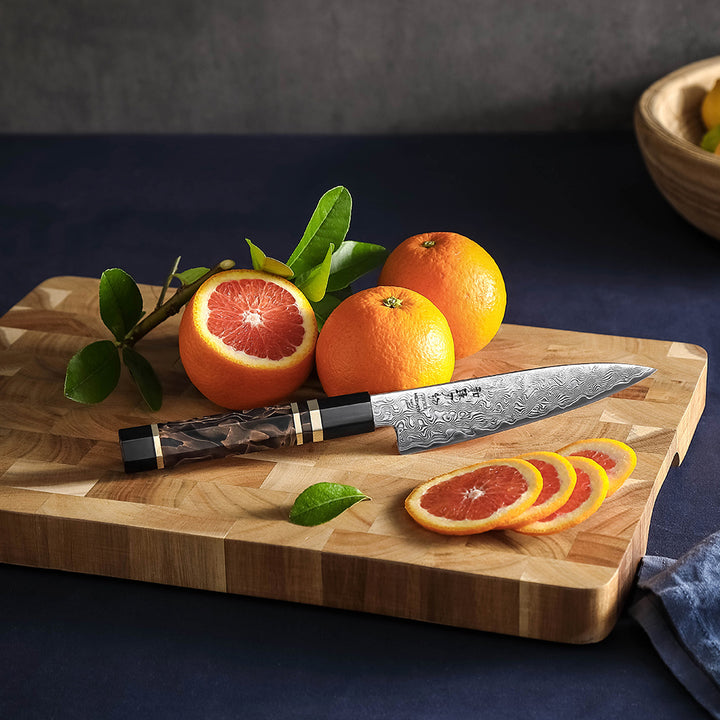 Hezhen X09 Retro groentemes naast sinaasappels op een plank