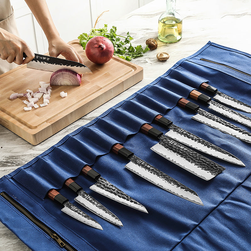 Open blauwe messentas met messen, snijplank en ingrediënten op de achtergrond