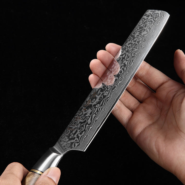 Close-up van het damastpatroon van het Hezhen B30 Master nakiri mes